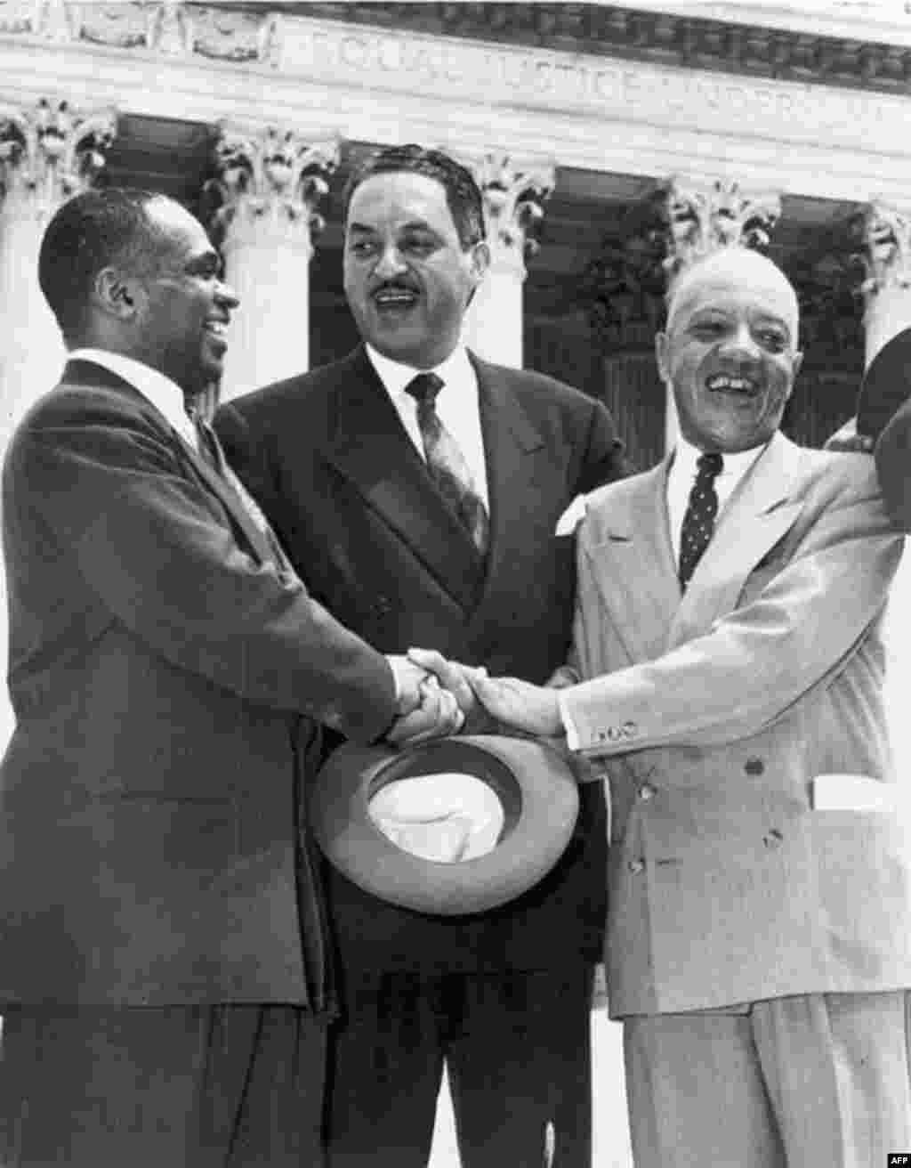 Lawyers Thurgood Marshall (center), George E.C. Hayes (left), and James Nabrit celebrate the Supreme Court&#39;s decision in Brown v. Board of Education on May 17, 1954. The ruling declared racial segregation in schools to be unconstitutional. In 1967, Thurgood Marshall became the first African-American to be appointed to the Supreme Court.