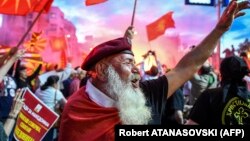 Macedonian protesters wave flags in front of the parliament building in Skopje during a demonstration earlier this year against a proposed change in the name of the country.