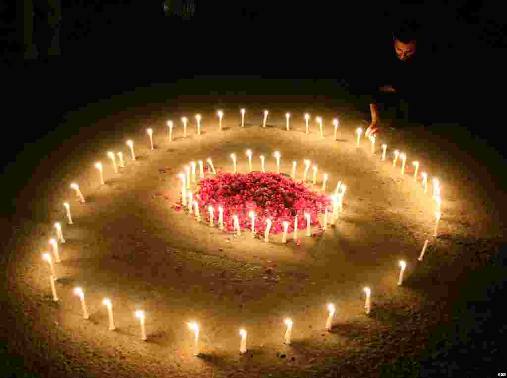 A Pakistani man lights candles in Karachi for the victims of deadly terrorist attacks in Paris. (epa/Shahzaib Akber)