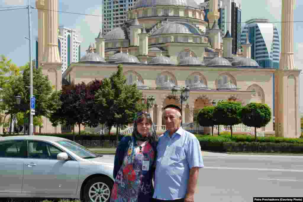 Prochazkova poses for a picture near the city&#39;s main mosque. She found that she needed to buy new clothes and a head scarf to meet local dress requirements. 