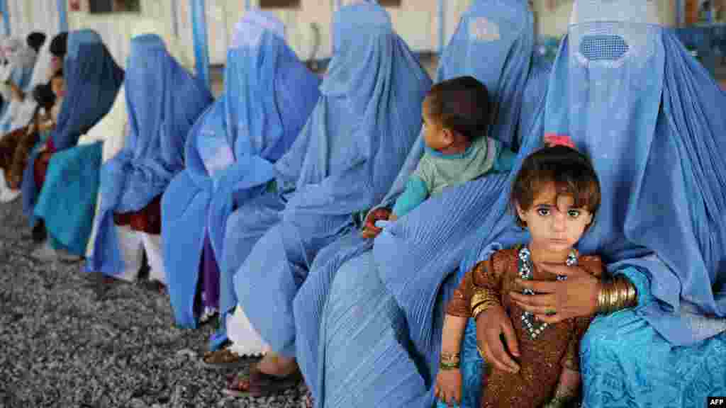 Afghan women and children at a UNHCR registration center in Pakistan. Nearly 26 million displaced people were receiving protection or assistance from the UN's refugee agency by the end of 2011.