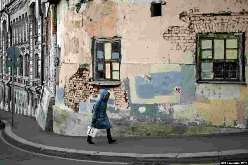 A woman walks along a street in the old Moscow neighborhood east of the Kremlin known as Kitai-Gorod, which dates from the 1500s,. (AFP/Kirill Kudryavtsev)