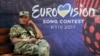 A Ukrainian serviceman rests near the Eurovision Song Contest fan zone on Khreshchatyk Street in downtown Kyiv. 