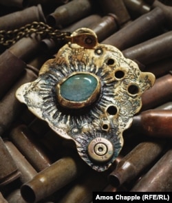 This pendant was made from Kalashnikov bullet casings.