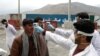 Afghan health workers check the temperature of travelers arriving in the capital Kabul on March 24