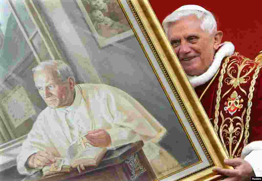 Pope Benedict holds a portrait of the late Pope John Paul II during a meeting with the faithful at Wadowice, Poland, in May 2006. John Paul moved a major step closer to Roman Catholic sainthood in January 2011 when Benedict approved a decree attributing a miracle to him and announced his beatification, a step from sainthood.