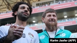 Egyptian star soccer player Mohammed Salah (left) holds hands with Chechen leader Ramzan Kadyrov.