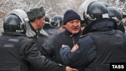 Kazakh police try to pacify protesters in Almaty who were rallying against measures taken by the authorities to suppress demonstrations in the oil town of Zhanaozen. At least 16 people were killed in violent clashes between police and demonstrators.
