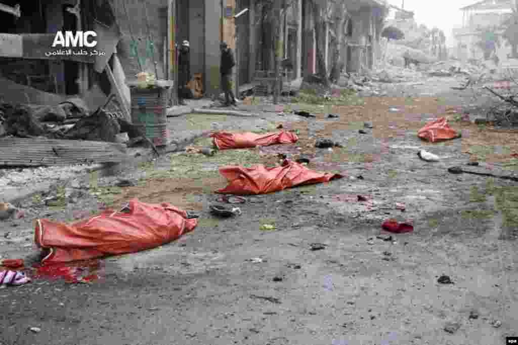 Dead bodies in body bags lie on the ground after a bombing in the Jibb al-Quebeh neighborhood of Aleppo, Syria. At least 45 people fleeing violence were reported killed in the shelling of the rebel-held neighborhood. (epa/Aleppo Media Center)