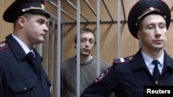 Bolshoi ballet dancer Pavel Dmitrichenko (center) pleaded not guilty to ordering an acid attack on the troupe's artistic director. 