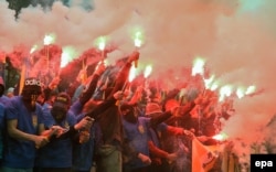 Azov members and supporters of various right-wing movements burn flares during a rally in front of parliament in Kyiv in 2016.