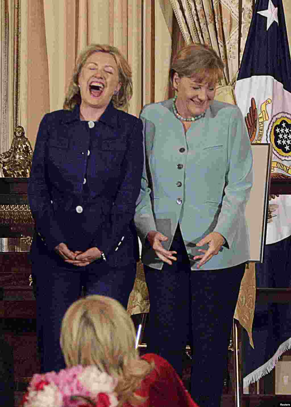 Clinton laughs with German Chancellor Angela Merkel during a luncheon held in Merkel&#39;s honor at the State Department on June 7, 2011.