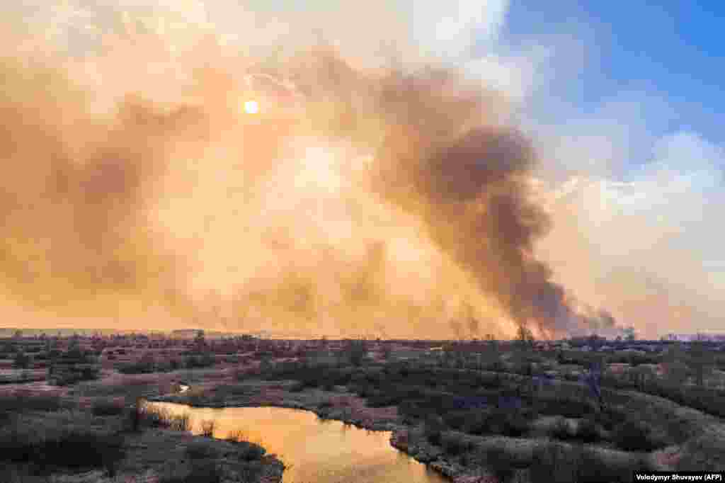 A column of smoke rises from the wildfire near the Chernobyl plant on April 10. Greenpeace Russia warned that fires blazing through the exclusion zone were much larger than authorities in Kyiv were admitting and that they posed a radiation risk.