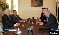 U.S. Secretary of State Rex Tillerson (left) and British Foreign Secretary Boris Johnson meet during a G7 foreign ministers summit in Lucca, Italy, on April 10.