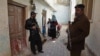 Pakistani police escort a team of polio health workers during a polio vaccination campaign in Quetta on February 15.