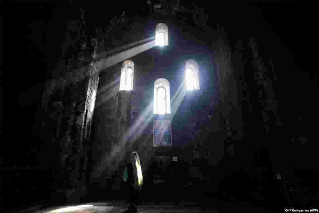 A woman prays in the St. Paul and Peter church at the ninth-century Tatev monastery of the Armenian Apostolic Church, some 270 kilometers outside of Yerevan. (AFP/Kirill Kudryavtsev)