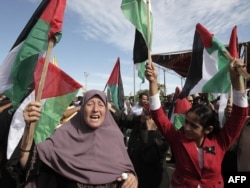 Palestinians from the Gaza Strip wait for the release of prisoners next to the Rafah crossing with Egypt.