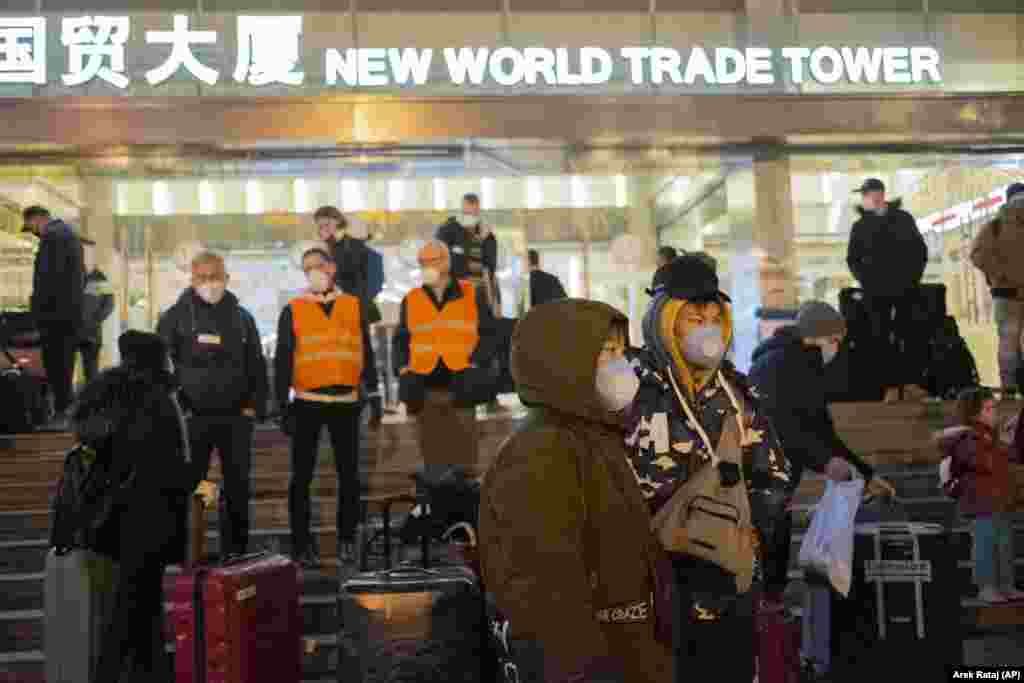 CHINA -- Evacuees gather on the steps of the New World Trade Tower Hotel before an evacuation flight for EU nationals in Wuhan in central China's Hubei Province, February 1, 2020