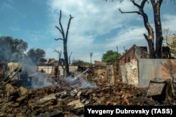 Firefighters search through debris from the blaze in Rostov-on-Don.