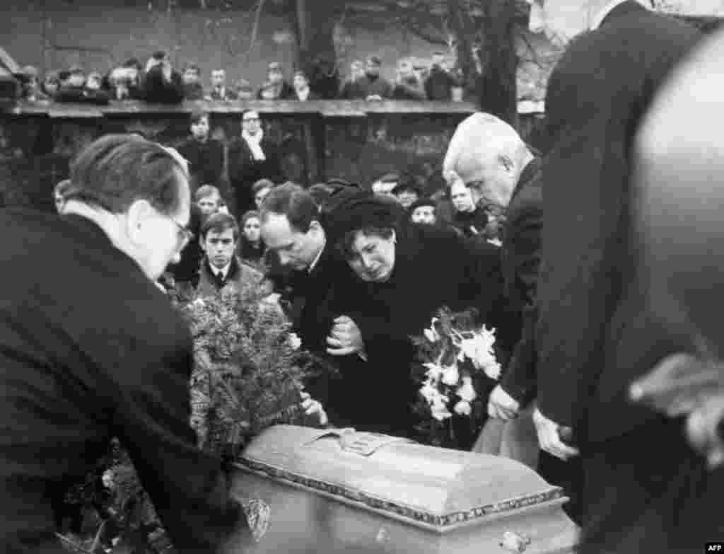 Palach&#39;s grieving mother, Libuse Palachova, is supported by her son Jiri during Jan&#39;s funeral in Prague.