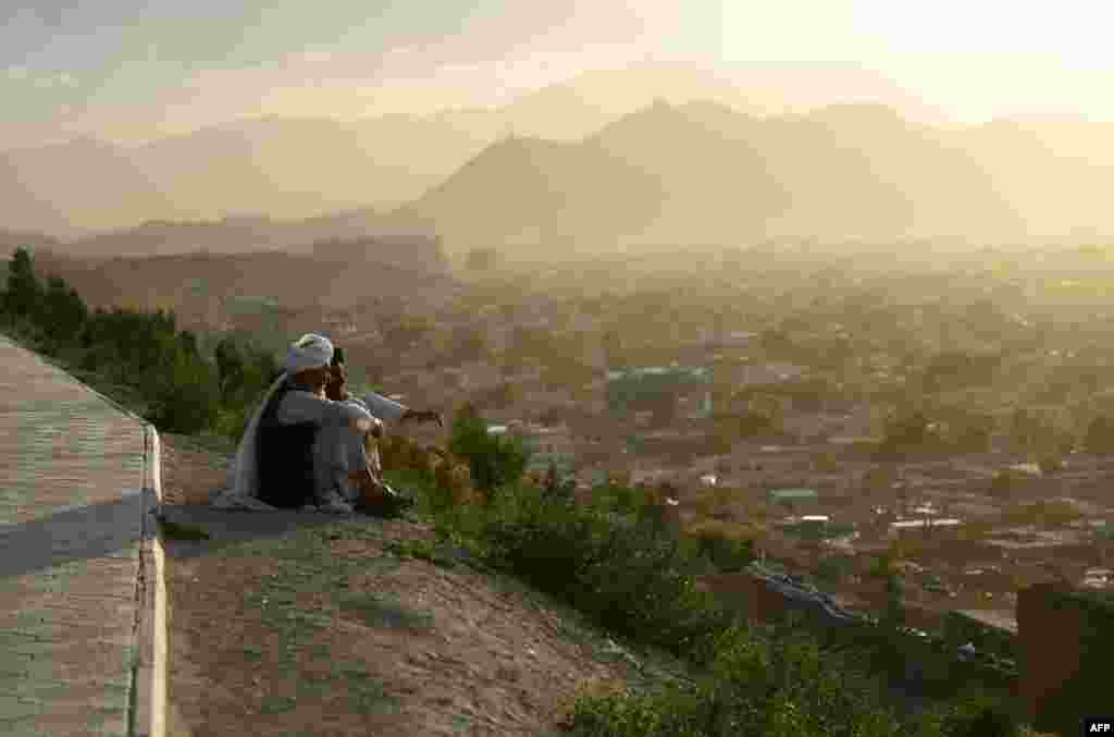 Kabul residents look out from the Wazir Akbar Khan hilltop overlooking the Afghan capital. (AFP/Farshad)
