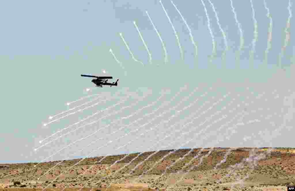 A helicopter throws flares as it participates in the "Eager Lion" military exercises south of Amman, Jordan. Some 8,000 personnel from 19 different nations are participating in the exercises. (AFP/Khalil Mazraawi)