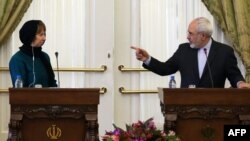 Iranian Foreign Minister Mohammad Javad Zarif gestures toward EU foreign affairs chief Catherine Ashton at a joint press conference in Tehran on March 9.