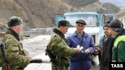 Russian border guards check entrants from Georgia to Russia at Verkhny Lars crossing point on the North Ossetian section of the Russian-Georgian border in April 2007.