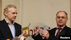 WikiLeaks founder Julian Assange (left) receives a CD containing data on offshore bank account holders from former Swiss private banker Rudolf Elmer in London.