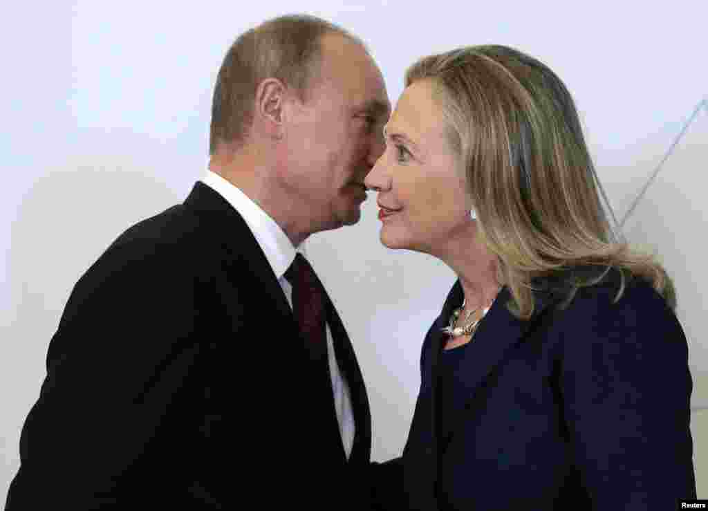 Russian President Vladimir Putin (left) welcomes U.S. Secretary of State Hillary Clinton upon her arrival at the Asia-Pacific Economic Cooperation (APEC) summit in Vladivostok, Russia, on September 8, 2012.