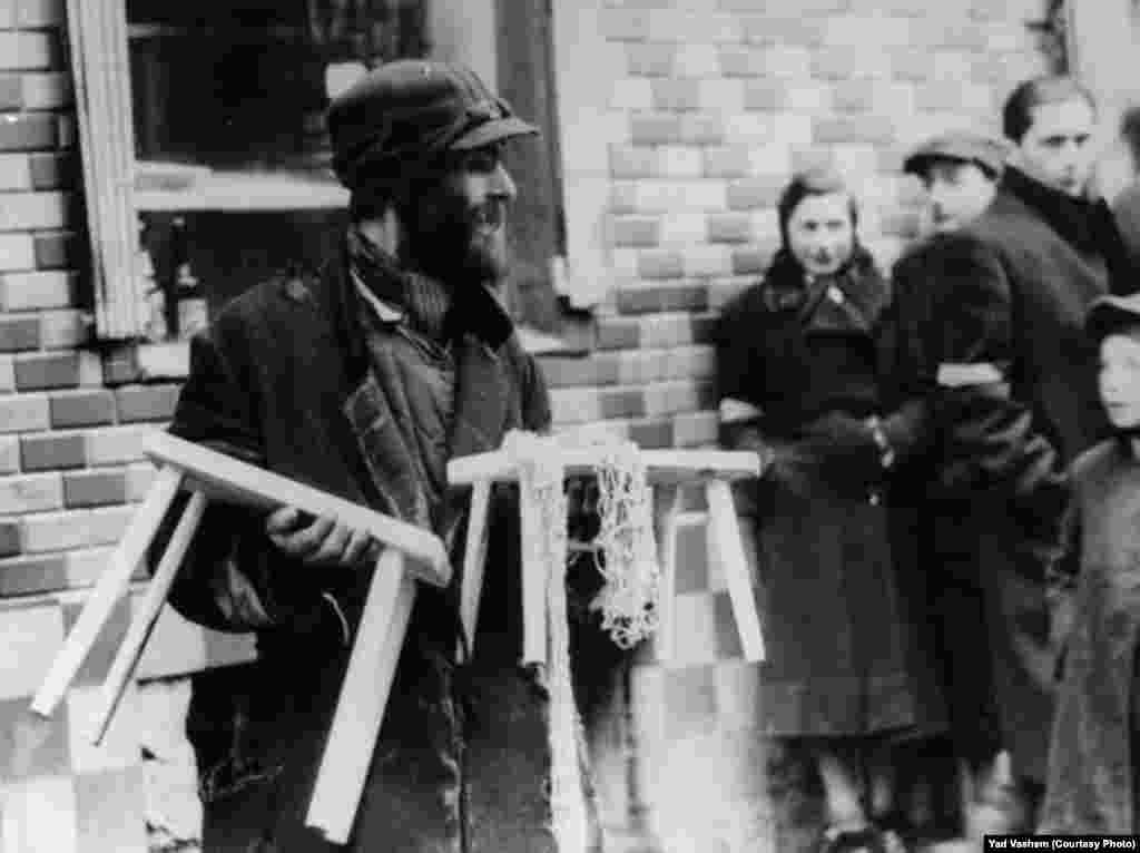 A resident of the ghetto displays his wares. 