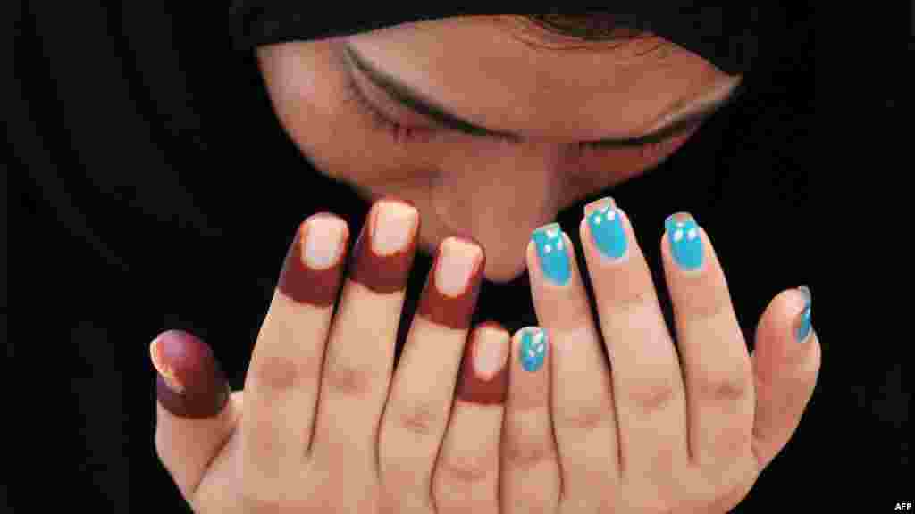 A woman offers Eid al-Fitr prayers at the Badshahi Masjid Mosque in Lahore, Pakistan.