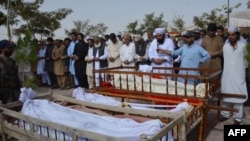 Relatives and residents offer funeral prayers for suicide blast victims in Quetta, Balochistan on August 8.