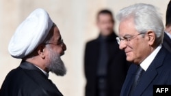 Iranian President Hassan Rohani (left) is welcomed by Italian President Sergio Mattarella at the Quirinale presidential palace in Rome on January 25.