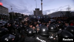 Police push protesters back during a demonstration in support of greater EU integration on Independence Square in Kyiv on November 29.