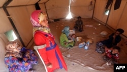 An Iraqi family who fled the city of Ramadi after it was seized by Islamic State militants, gathers inside their tent at a camp for the internally displaced in Amriyat al-Fallujah, 30 kilometers south of Fallujah, on May 22. 