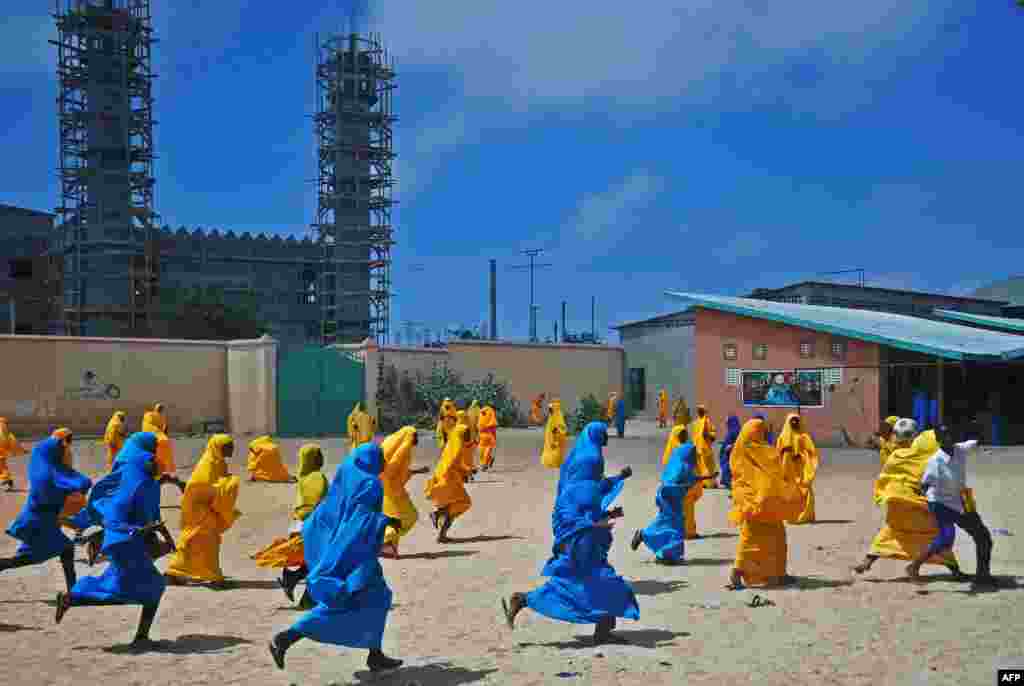 Somali schoolgirls play football during lunch break at an elementary school in Mogadishu. (AFP/Mohamed Abdiwahab)