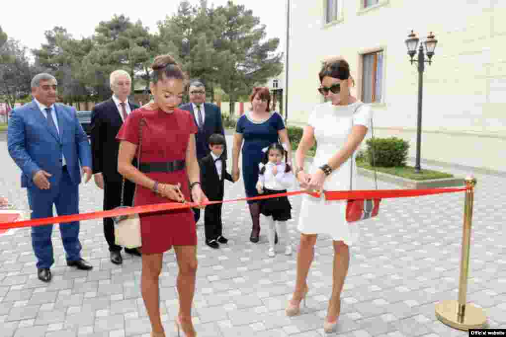 Mehriban Aliyeva, meanwhile, has put in a number of her own public appearances. Here, the Azerbaijani first lady (right) cuts the ribbon at the opening of a Baku kindergarten with her daughter, Leyla, on September 25. 