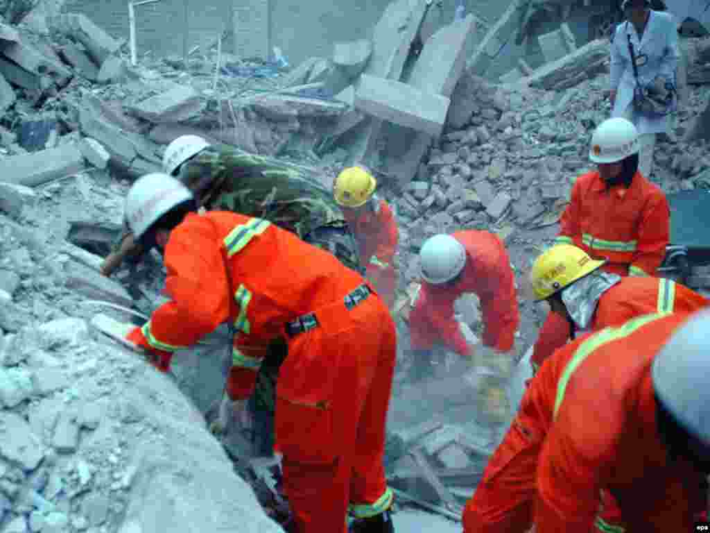 China -- Rescuers search through the rubble of a primary school that collapsed during the earthquake, in Liangping county, 12May2008