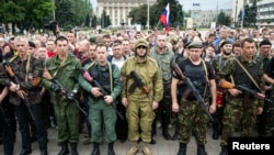Armed pro-Russian separatists of the self-proclaimed Donetsk People's Republic pledge an oath during a ceremony in Donetsk on June 21.