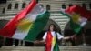 A woman waves Kurdish flags in Diyarbakir, Turkey, September 25, 2017. REUTERS