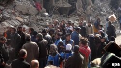 Palestinians wait for food supplies at the Palestinian Yarmouk refugee camp in January 2014.