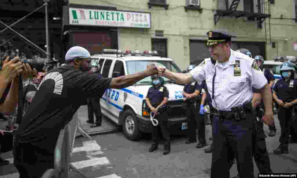 NYPD Deputy Police Chief McCarthy greets protesters as they take part in a solidarity march for George Floyd, Tuesday, June 2, 2020, in New York. Floyd, a black man died after being restrained by Minneapolis police officers on May 25.(AP Photo/Eduardo Munoz Alvarez)