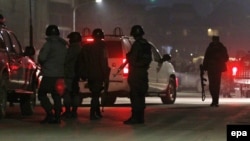 Members of the Afghan security services arrives an attack in Kabul near the Spanish Embassy in Kabul on December 11.
