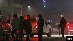 Members of the Afghan security services arrives at the scene of an attack in Kabul late on December 11.