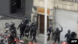 Iranian security forces on motorcycles surround opposition protesters during clashes in Tehran in 2009.
