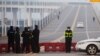 Police stand at a roadblock at a bridge crossing the Yangtze River to Hubei province in Jiujiang, Jiangxi province, China, as the country is hit by an outbreak of a new coronavirus, January 30, 2020