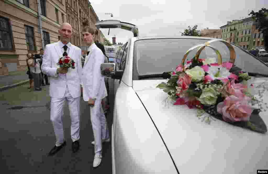 Same-sex couple Yury Gavrikov (left) and Maksim Lysak pose for a picture as they arrive at a registry office to apply for a marriage licence in St. Petersburg, Russia. Their application was not accepted. (Reuters/Artur Bainozarov)