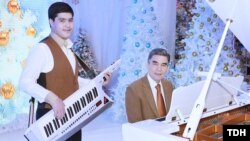 Gurbanguly Berdymukhammedov (right) and his grandson fiddle in the New Year.