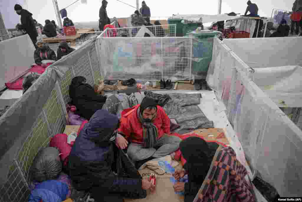Migrants sit in a temporary shelter at the Lipa camp. Despite the fire, Bosnian authorities have failed to find new accommodations for the migrants at Lipa. State officials blame local authorities for being unwilling to open the Bira camp again, so they could have time to prepare Lipa for the long-term housing of migrants.